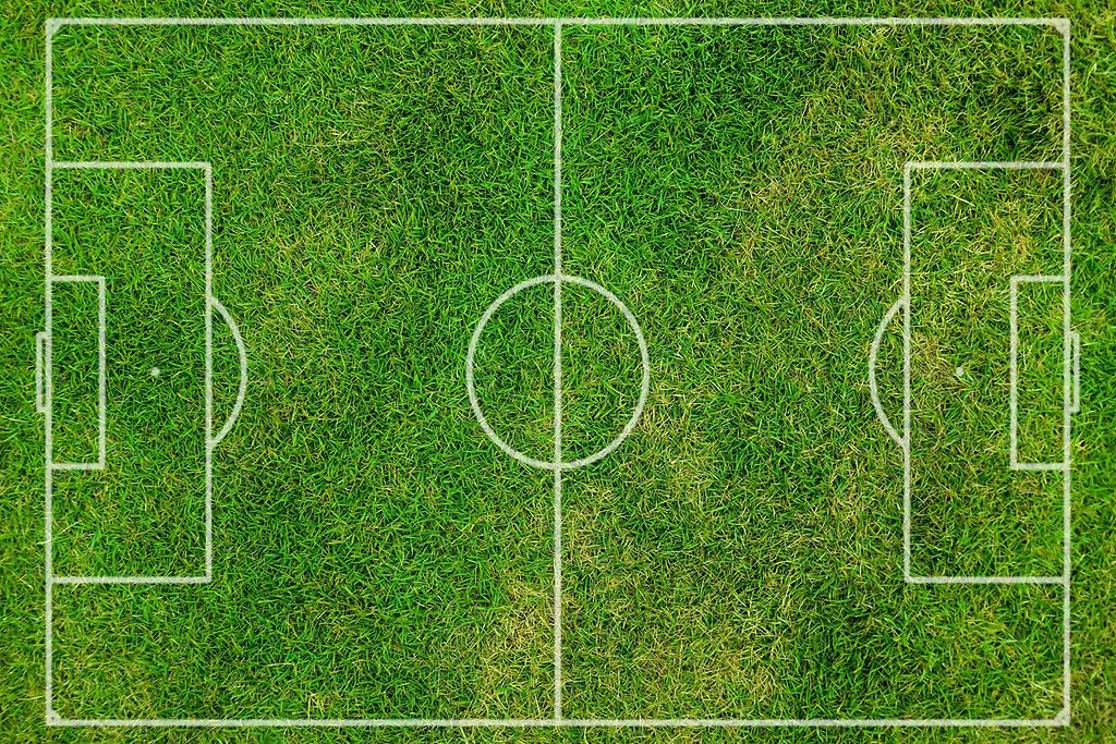 En grön rektangulär form med gräs och vita raka sträck