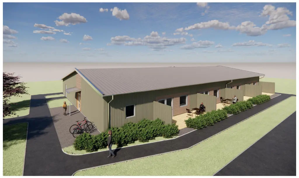 Konceptbild på ny gruppbostad. Enplanshus med grå fasad, svart tak, fyra lägenheter på denna sida med separata uteplatser till varje lägenhet