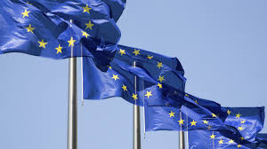 Tre EU-flaggor vajar i vinden.